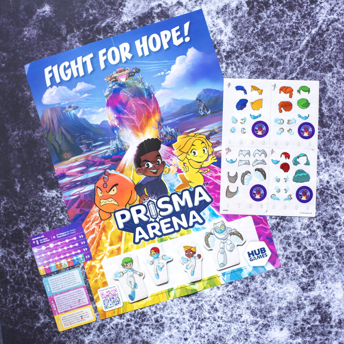 Prisma Arena by Hub Games Promotional Pack. Photo shoes the stickers, poster, heroes and cards that are in the set on a black cracked background.