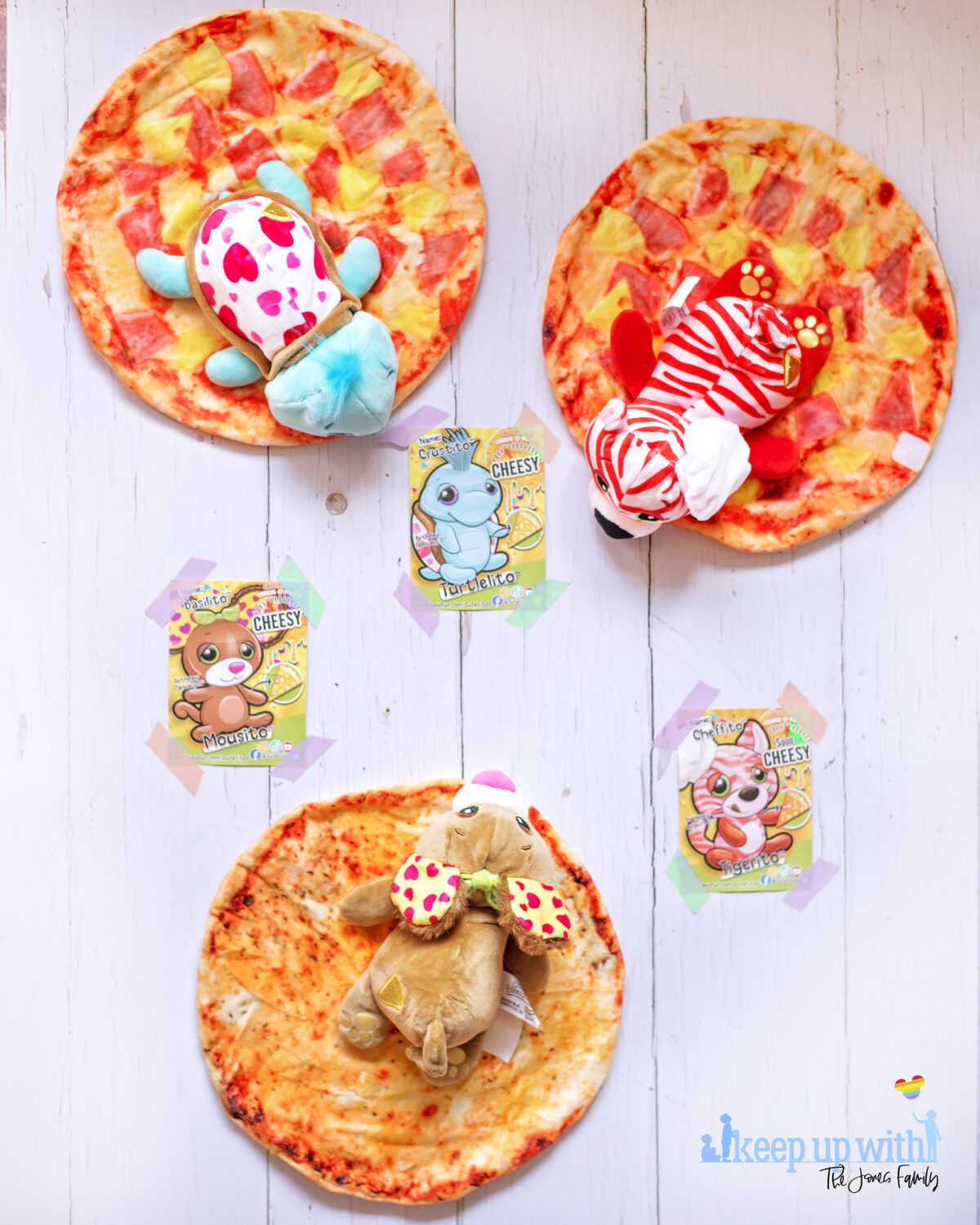 Cuteitos Pizzaitos. Image shows three Cuteitos Pizzaito toys unwrapped on a white wooden background. 