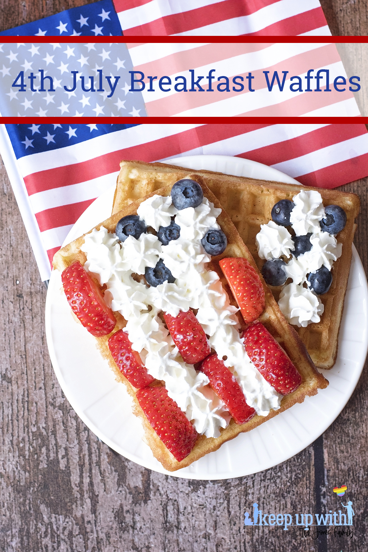 Image shows rectangular sweet breakfast waffles on a white vera wang plate. The waffles are decorated in the style of the American Flag. There are sliced strawberries for the red stripes, blueberries for the space around the stars, and cream piped as the white stars and stripes. The plate is set on a dark hardwood background and there is a small American Flag next to it. Image by Sara-Jayne Jones, Keep Up With The Jones Family.