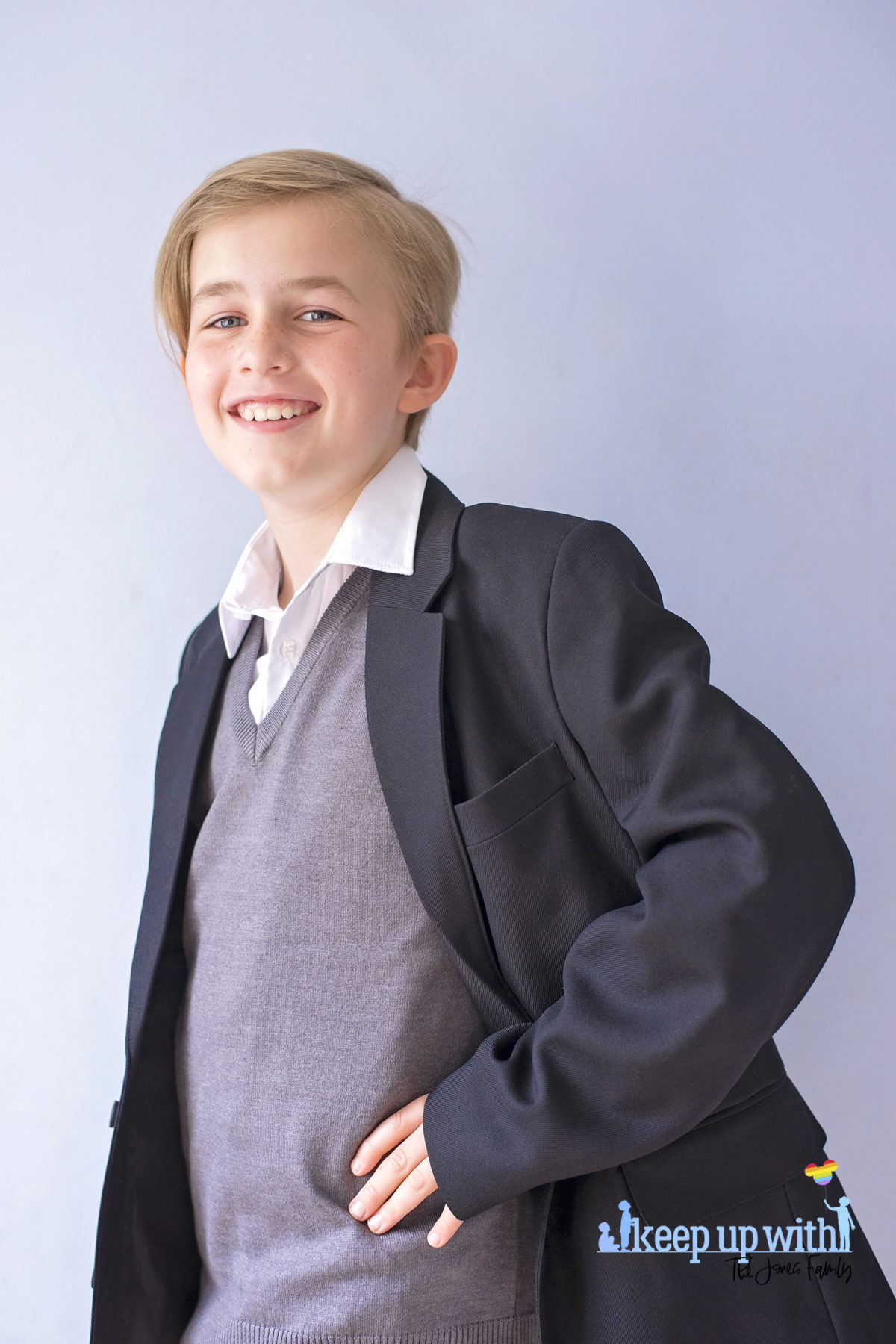 Image shows a boy wearing Trutex School Uniform. Black blazer, grey v-neck pullover and white shirt. Image by Sara-Jayne for Keep Up With The Jones Family